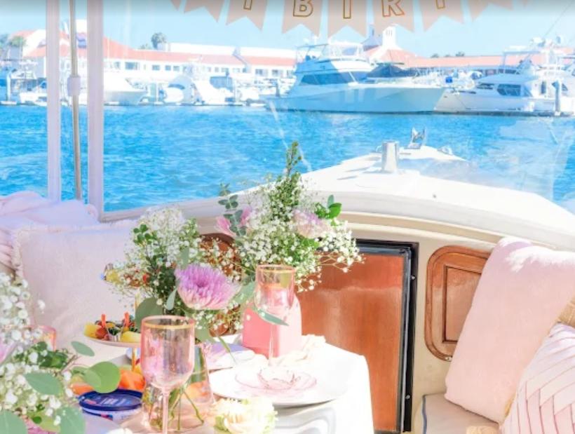 Elegant birthday table setup on boat with flowers