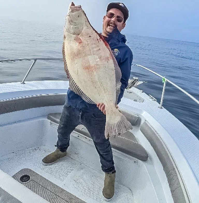 Angler proudly displaying large halibut catch