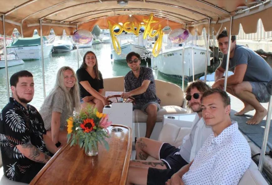 Group of friends celebrating birthday on boat