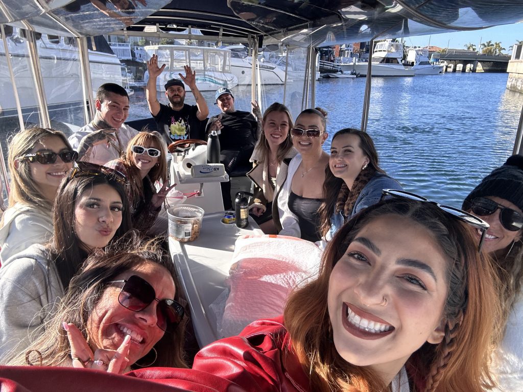 Group celebrating with balloons on Duffy boat