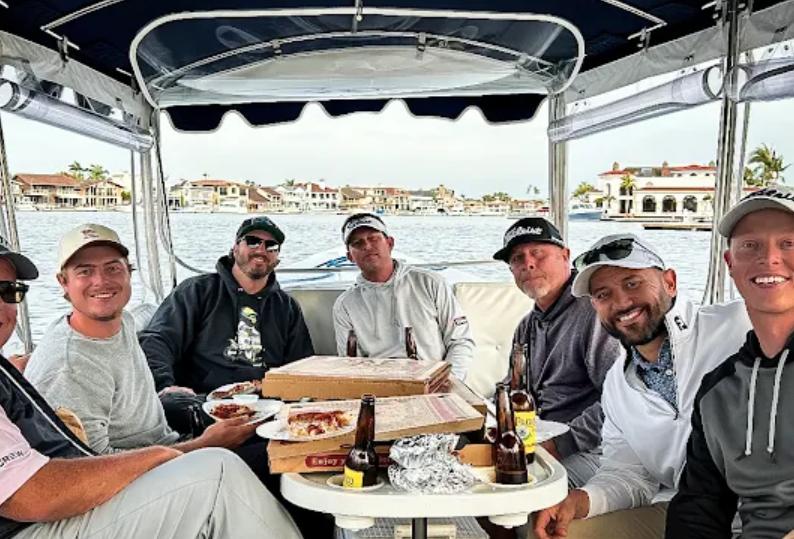 Group enjoying pizza and beers on boat