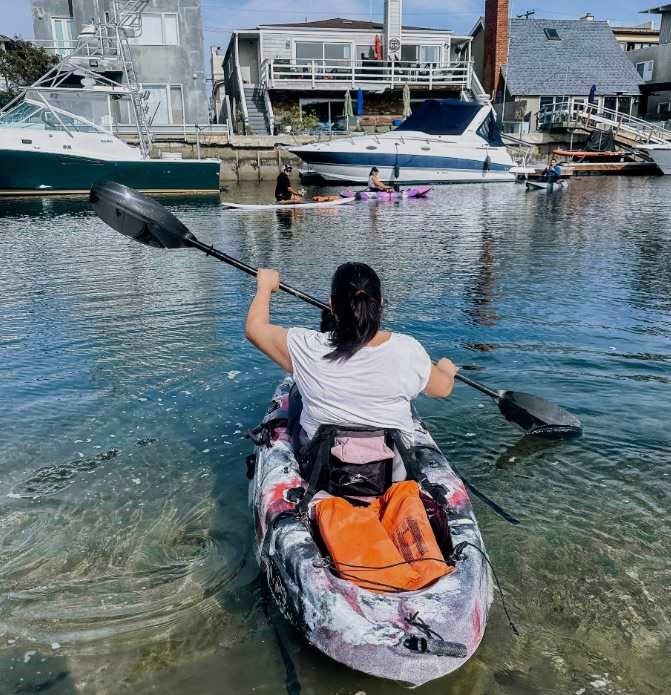 Woman kayaking in harbor