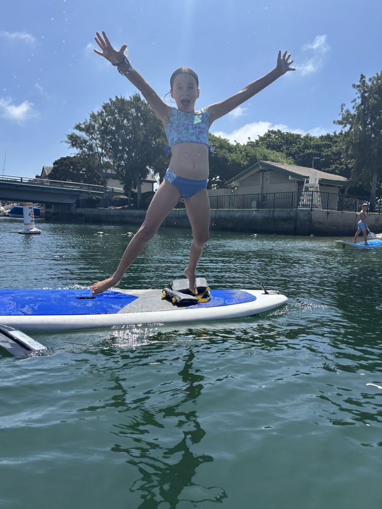 Girl jumping on SUP
