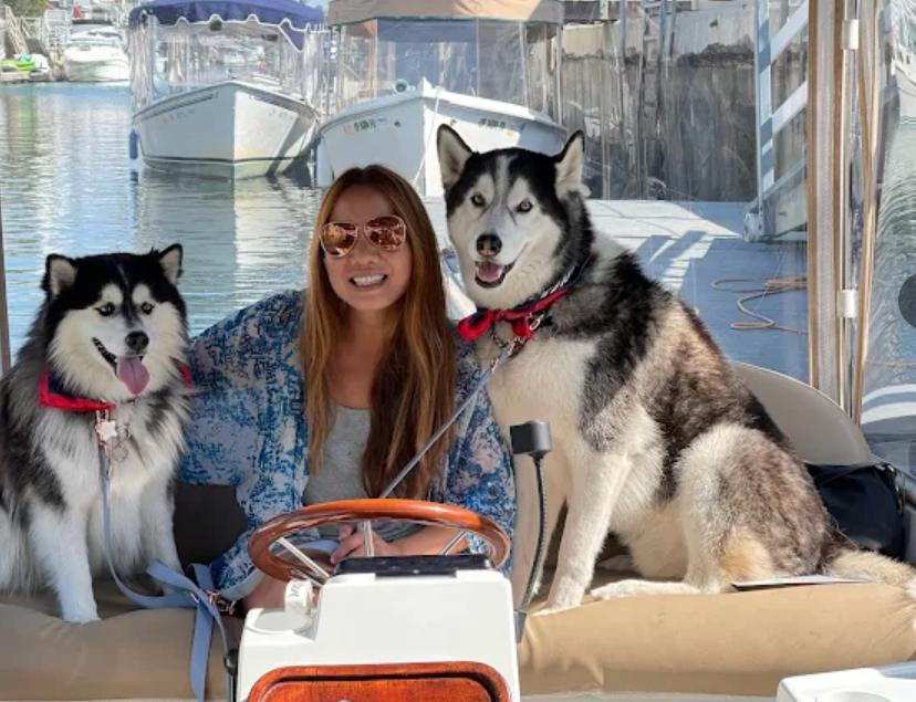 Woman with two huskies on Duffy boat