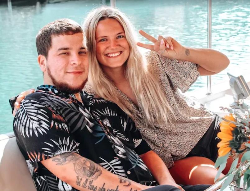 Happy young couple on romantic boat cruise